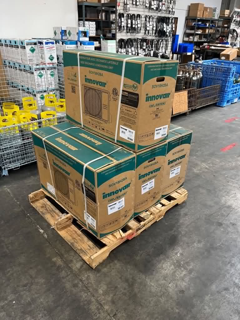 Pallet of new boxed Innovair inverter mini-split condensing units staged at the ColdTech supply warehouse before residential installation